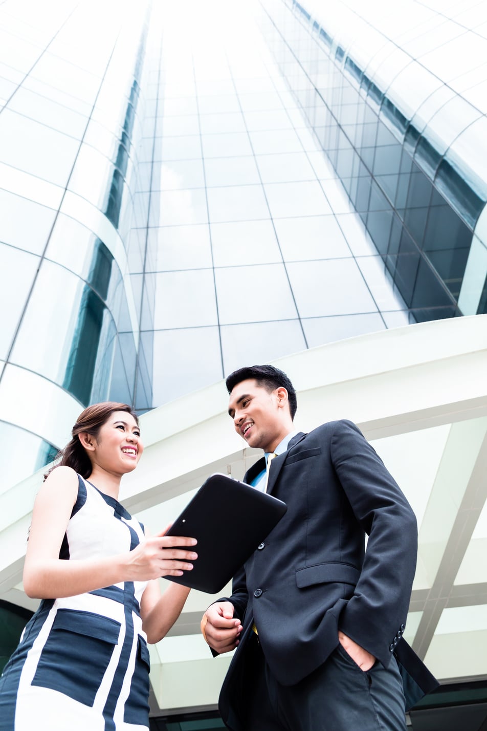 Asian Businesspeople Working Outside On Pad