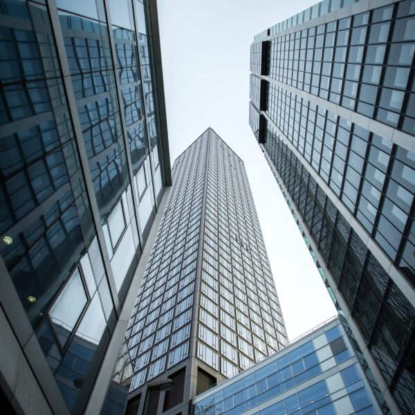 Vertical low angle shot of high rise skyscrapers in a glass facade in Frankfurt, Germany A vertical low angle shot of high rise skyscrapers in a glass facade in Frankfurt, Germany