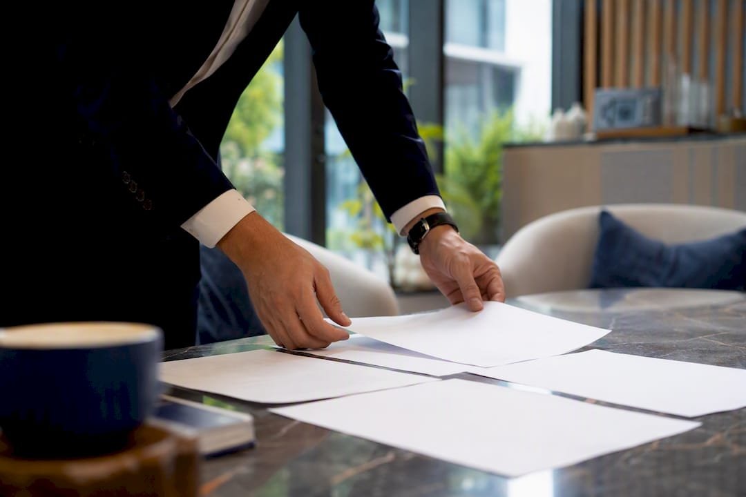Hands arranging spreadsheet sheets in Singapore office