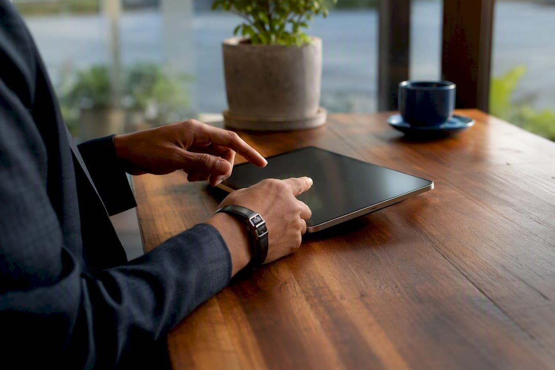 Businessperson saving digital confirmation on tablet