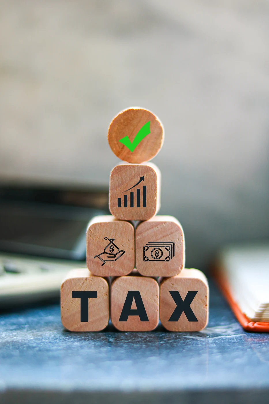 Tax and finance symbols on wooden blocks